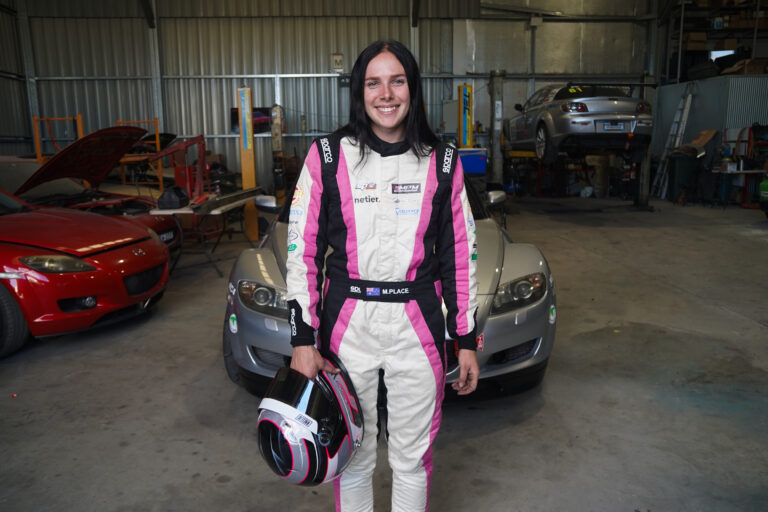 Maisie Place in her race suit